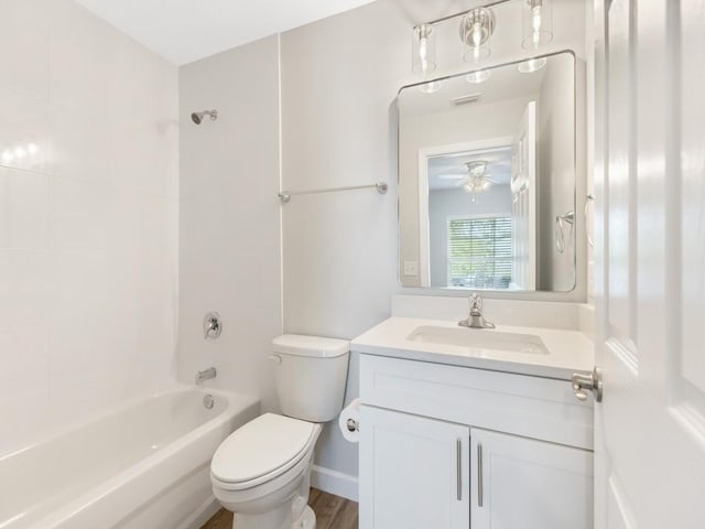 full bathroom featuring vanity, tiled shower / bath combo, and toilet