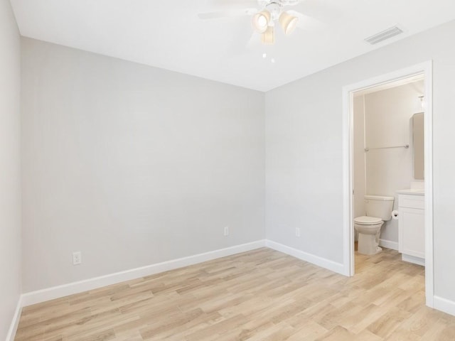 unfurnished bedroom featuring light hardwood / wood-style flooring, ceiling fan, and ensuite bathroom