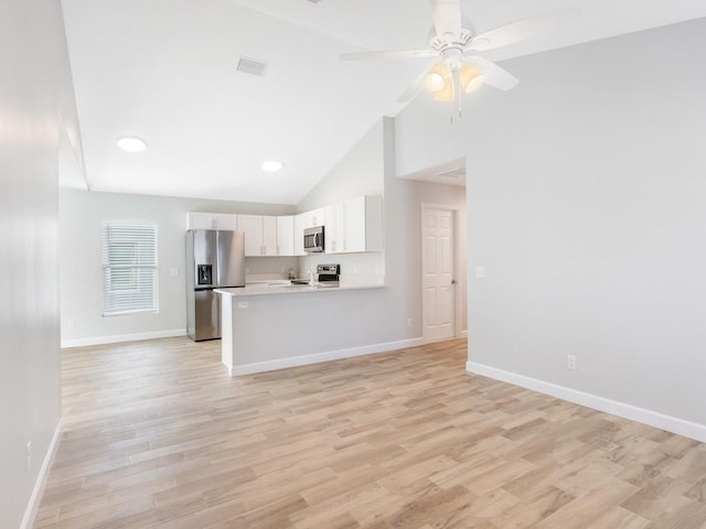 kitchen with light hardwood / wood-style flooring, kitchen peninsula, ceiling fan, stainless steel appliances, and white cabinets