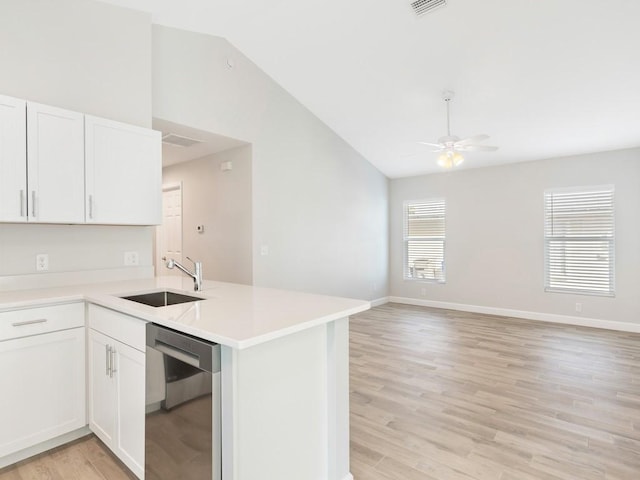 kitchen featuring white cabinetry, sink, stainless steel dishwasher, ceiling fan, and light wood-type flooring