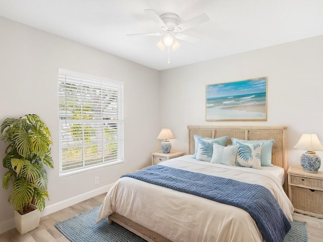 bedroom with ceiling fan and light hardwood / wood-style floors