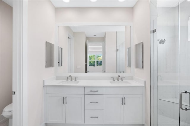 bathroom with vanity, toilet, and an enclosed shower