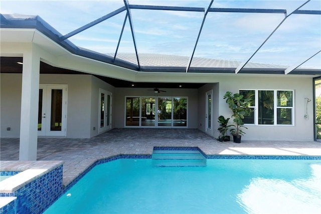 rear view of house featuring stucco siding, a patio, ceiling fan, and french doors