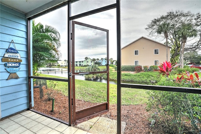 unfurnished sunroom featuring a water view