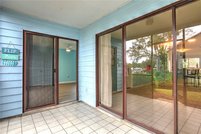 interior space with wooden walls and light tile patterned floors