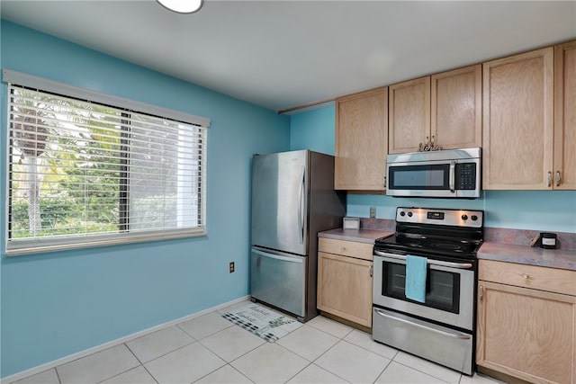 kitchen featuring light brown cabinets, light tile patterned floors, and appliances with stainless steel finishes