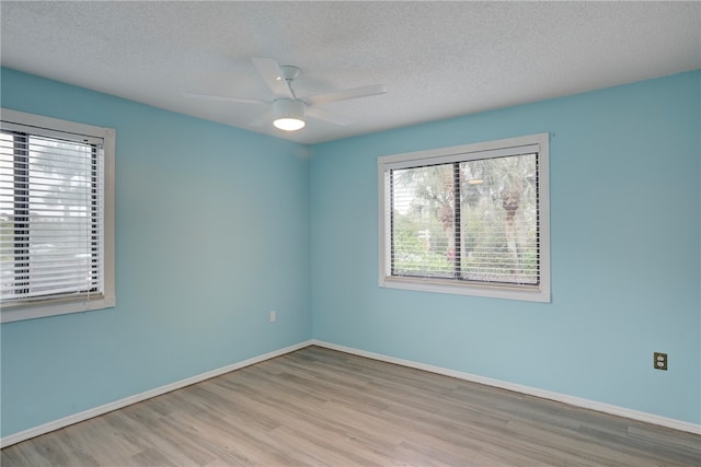 spare room featuring ceiling fan, a textured ceiling, and light hardwood / wood-style flooring