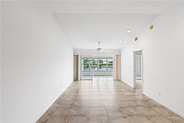 tiled spare room with ceiling fan and lofted ceiling