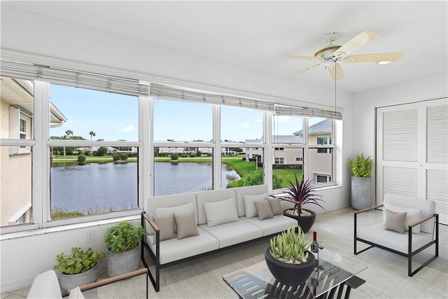 sunroom / solarium featuring a water view and a healthy amount of sunlight