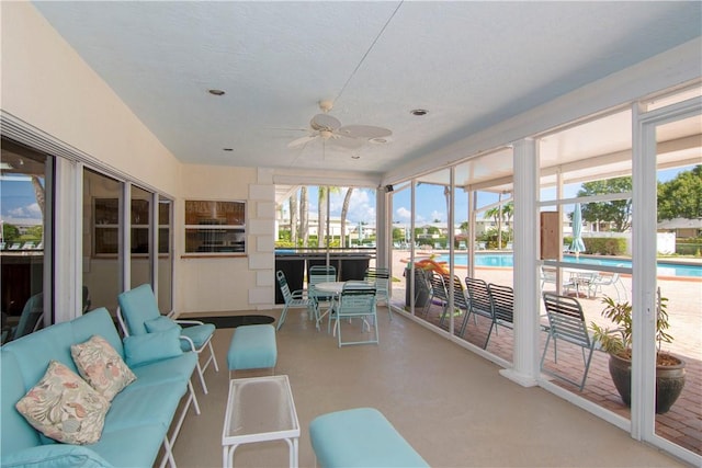 sunroom featuring ceiling fan