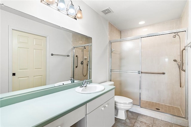 bathroom featuring walk in shower, tile patterned flooring, vanity, and toilet