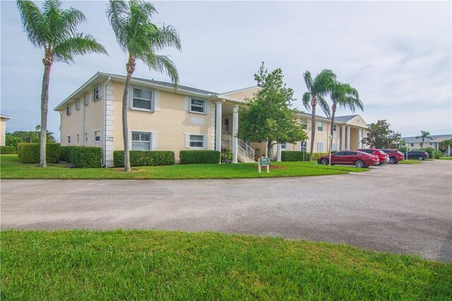 620 E Lake Jasmine Cir Unit 203, Vero Beach, FL 32962 - view of building exterior featuring uncovered parking