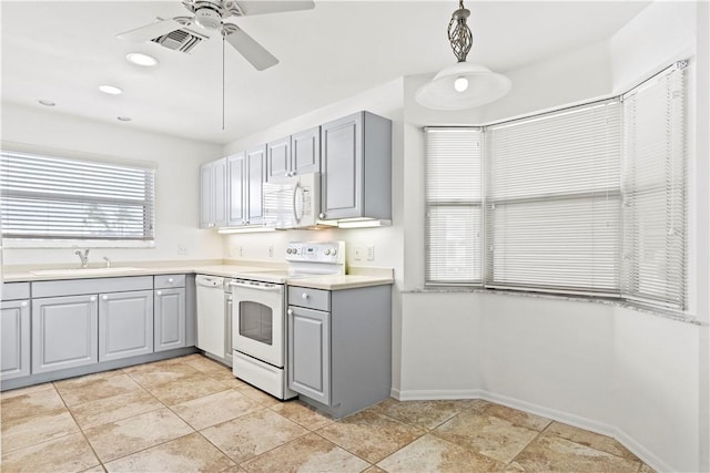 kitchen with white appliances, gray cabinets, ceiling fan, and sink