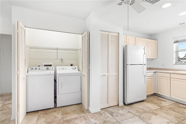 washroom featuring light tile patterned floors, washer and clothes dryer, and ceiling fan