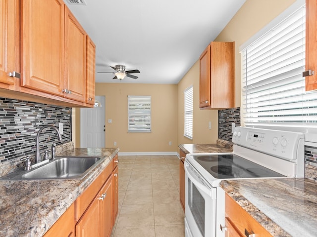 kitchen featuring white range with electric stovetop, backsplash, sink, and light tile patterned floors