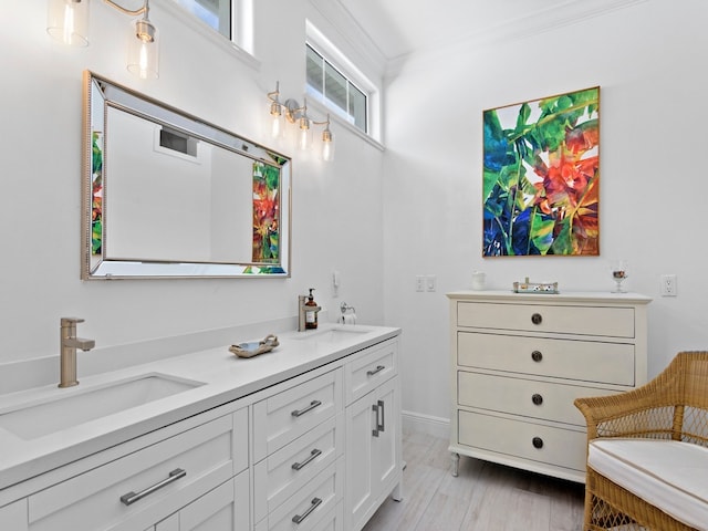 bathroom featuring crown molding and vanity