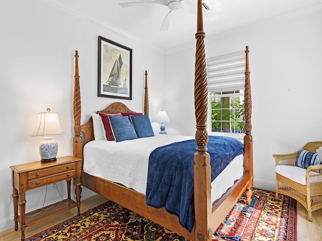 bedroom featuring ceiling fan, crown molding, and wood-type flooring