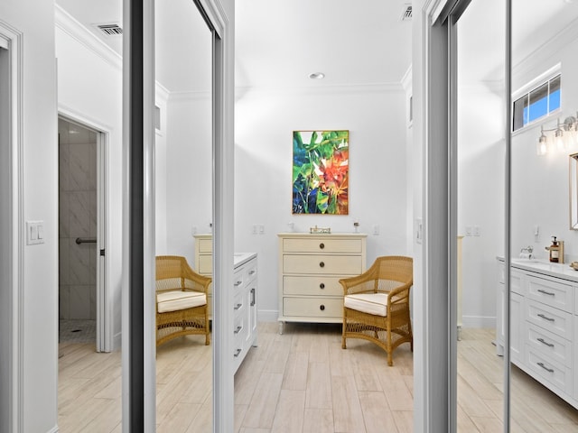 bathroom featuring vanity, hardwood / wood-style floors, and crown molding