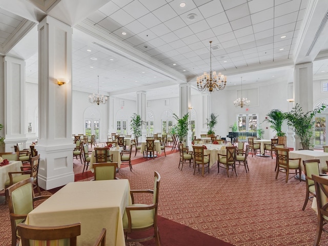 dining area with a towering ceiling, carpet flooring, and ornate columns