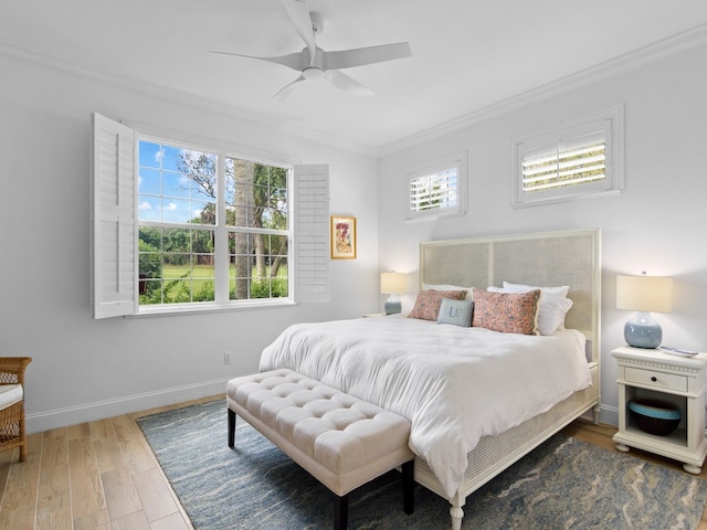 bedroom with ceiling fan, crown molding, and wood-type flooring