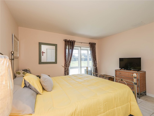 bedroom with light tile patterned flooring