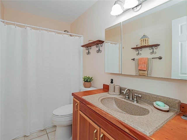 bathroom with tile patterned flooring, vanity, and toilet