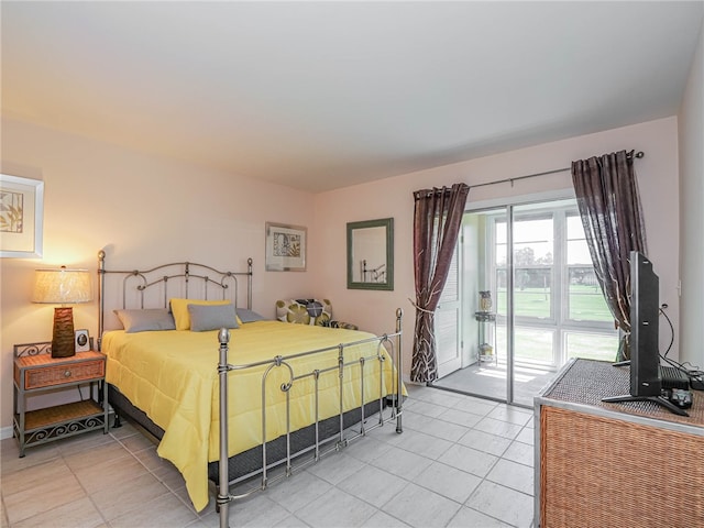 bedroom featuring access to exterior and tile patterned floors