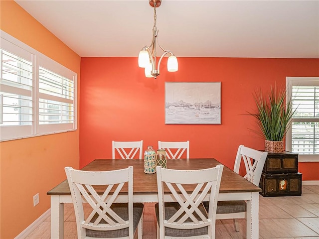 55 Woodland Dr Unit 206, Vero Beach, FL 32962 - dining space with a chandelier and baseboards