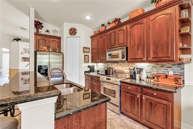 kitchen featuring open shelves, backsplash, appliances with stainless steel finishes, a sink, and dark stone counters