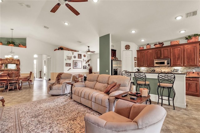 living area featuring arched walkways, ceiling fan with notable chandelier, lofted ceiling, and visible vents