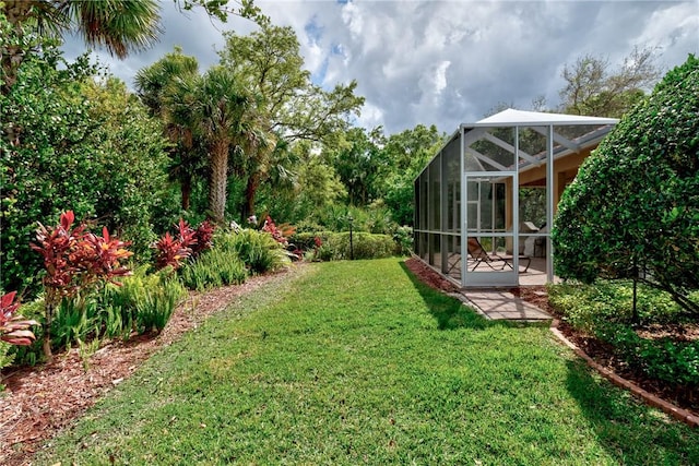 view of yard with glass enclosure