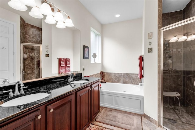 full bathroom with a stall shower, a sink, a bath, and a notable chandelier