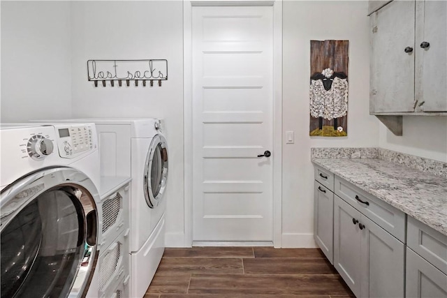 washroom featuring cabinets and washing machine and clothes dryer