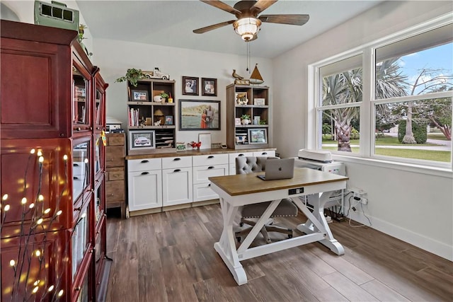 home office with dark hardwood / wood-style floors and ceiling fan