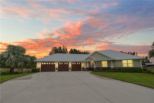 view of front of house with a garage and a yard