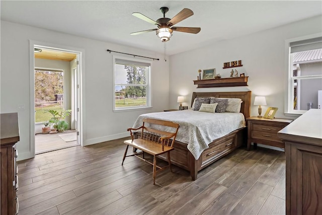 bedroom with ceiling fan and dark wood-type flooring