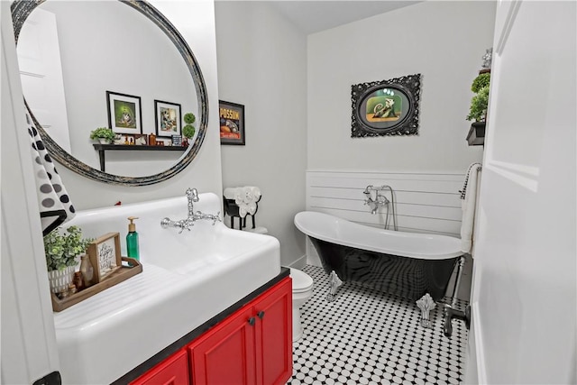 bathroom with tile patterned flooring, vanity, a bathtub, and toilet