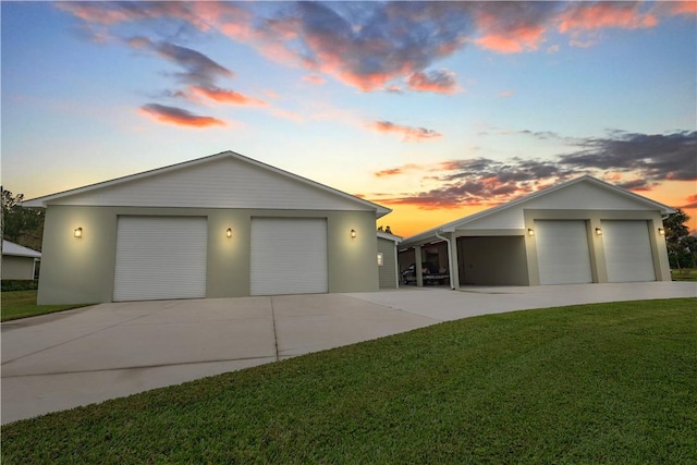 view of front of house with an outbuilding, a garage, and a lawn