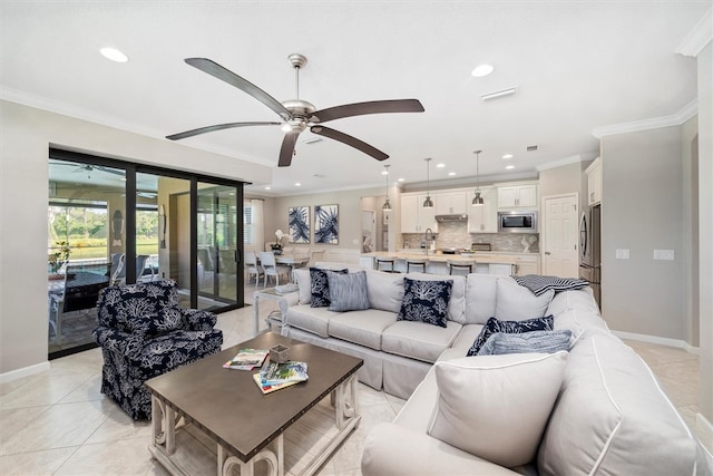 living room with ceiling fan, light tile patterned flooring, and ornamental molding