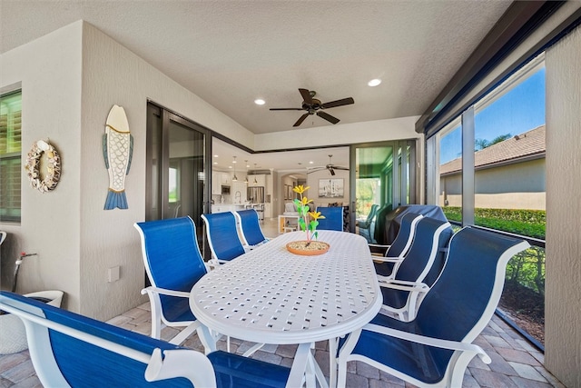 sunroom featuring ceiling fan