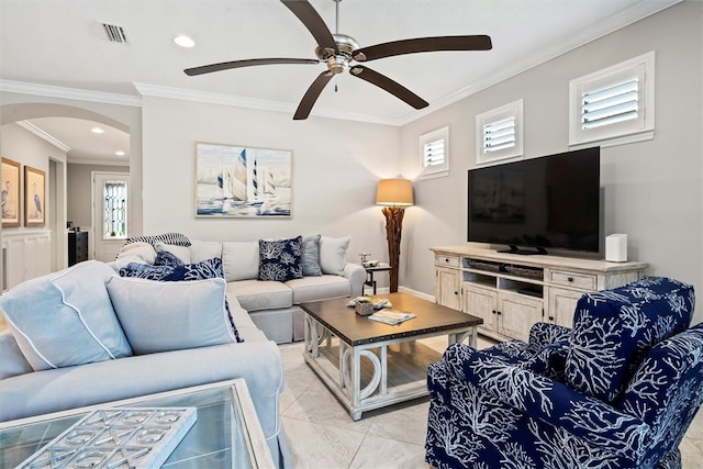 living room featuring plenty of natural light, light tile patterned flooring, crown molding, and ceiling fan