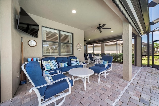 view of patio / terrace with ceiling fan, a lanai, and an outdoor hangout area