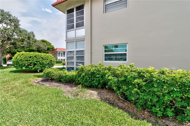 view of side of property with a yard