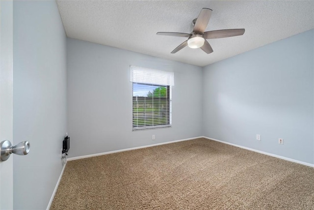 empty room with ceiling fan, a textured ceiling, and carpet flooring