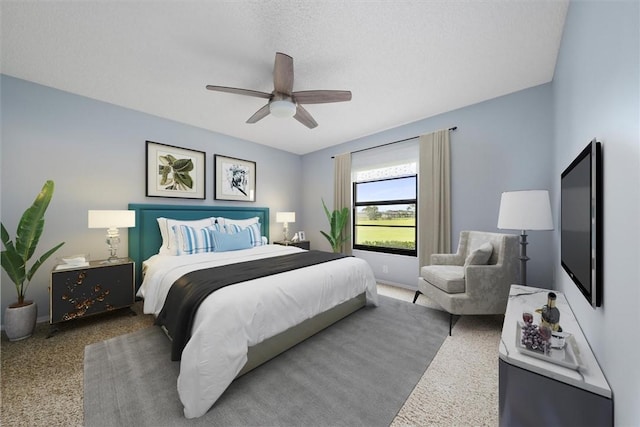 carpeted bedroom featuring a textured ceiling and ceiling fan