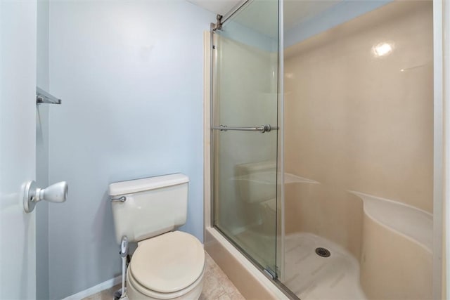 bathroom with toilet, walk in shower, and tile patterned flooring