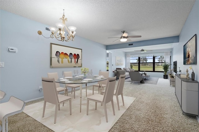 dining room featuring light colored carpet, ceiling fan with notable chandelier, and a textured ceiling