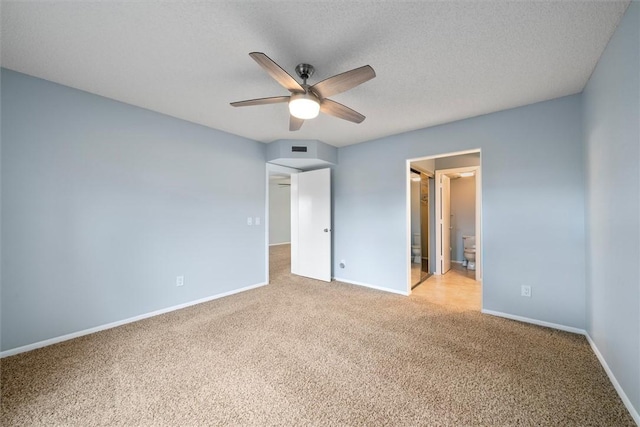 unfurnished bedroom featuring light carpet, ceiling fan, a textured ceiling, and connected bathroom