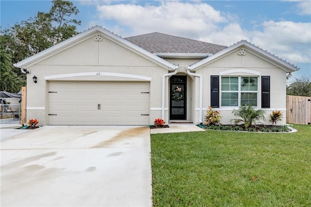 single story home featuring a garage and a front lawn