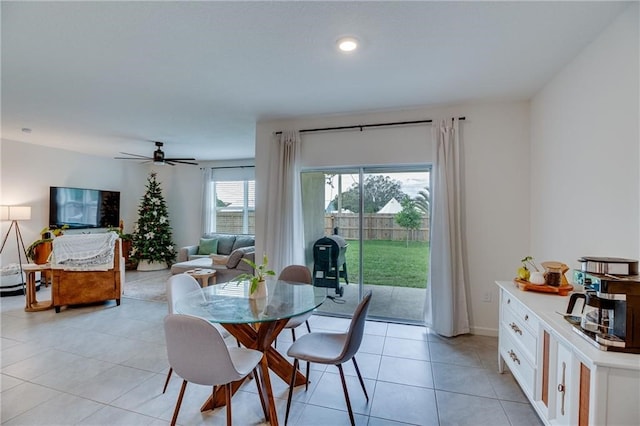 tiled dining area with ceiling fan